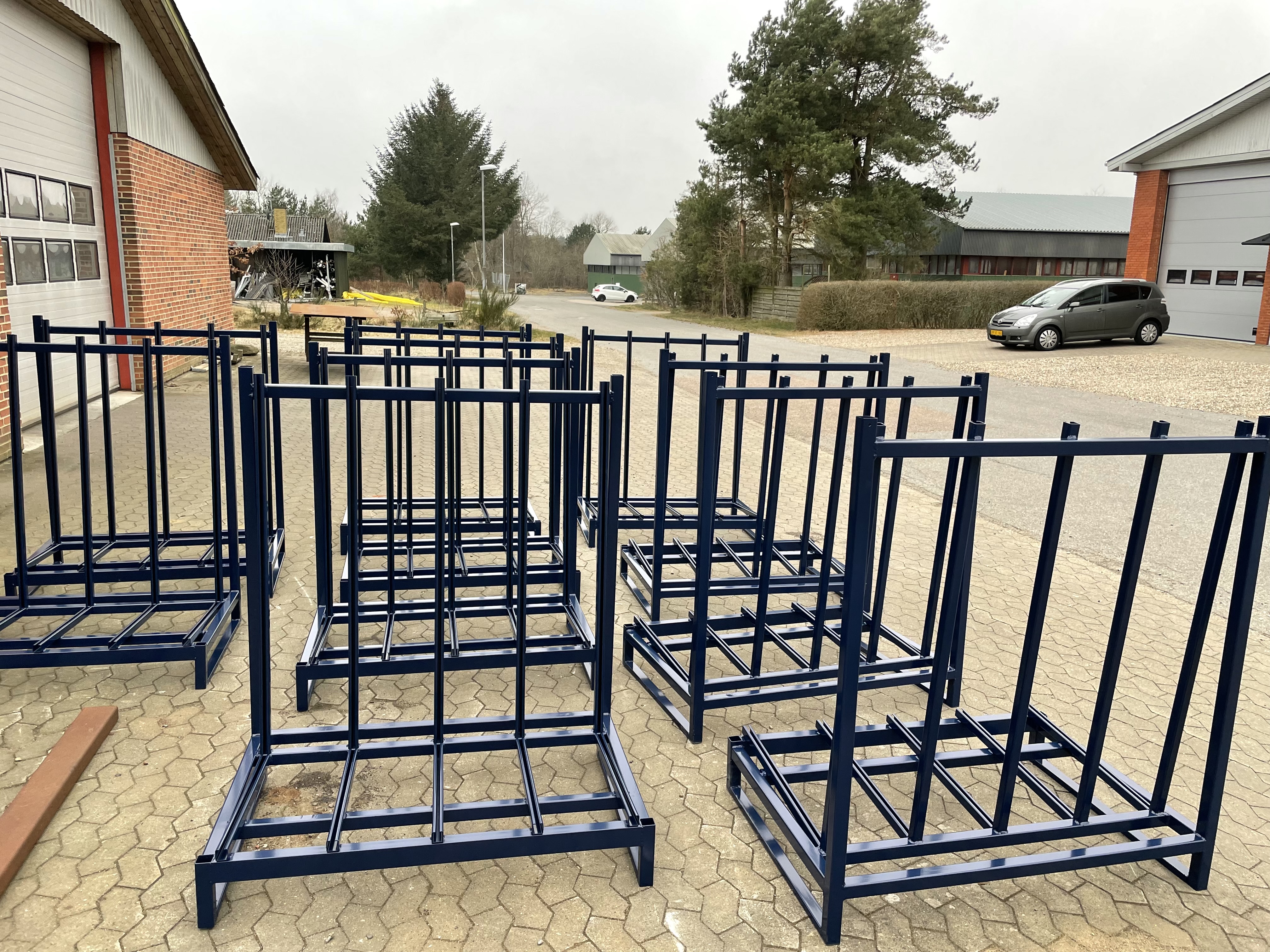 Series of black fixed transport racks outside the workshop