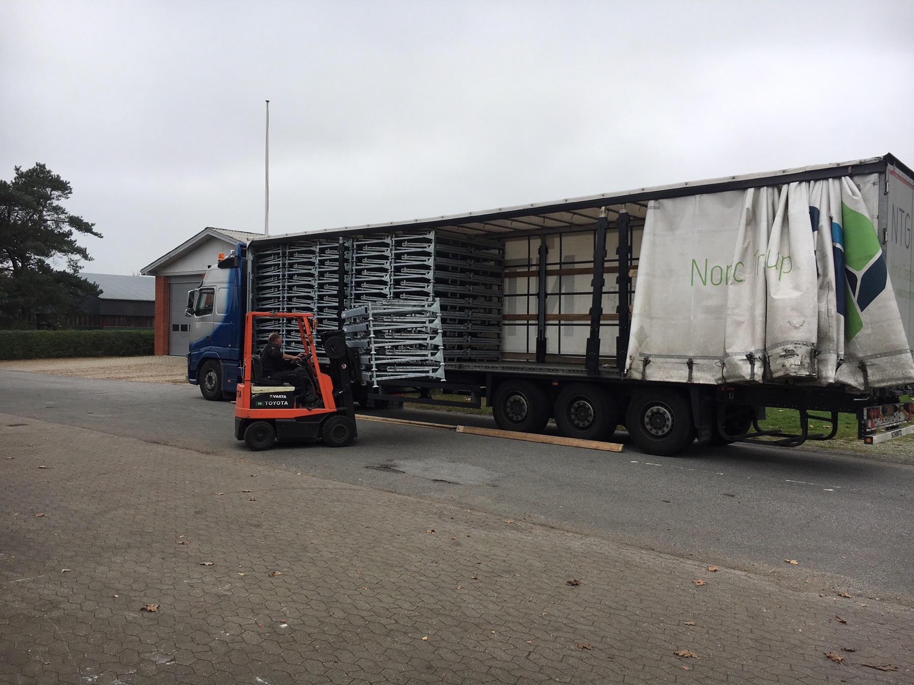 Folded L-Racks being loaded into a truck
