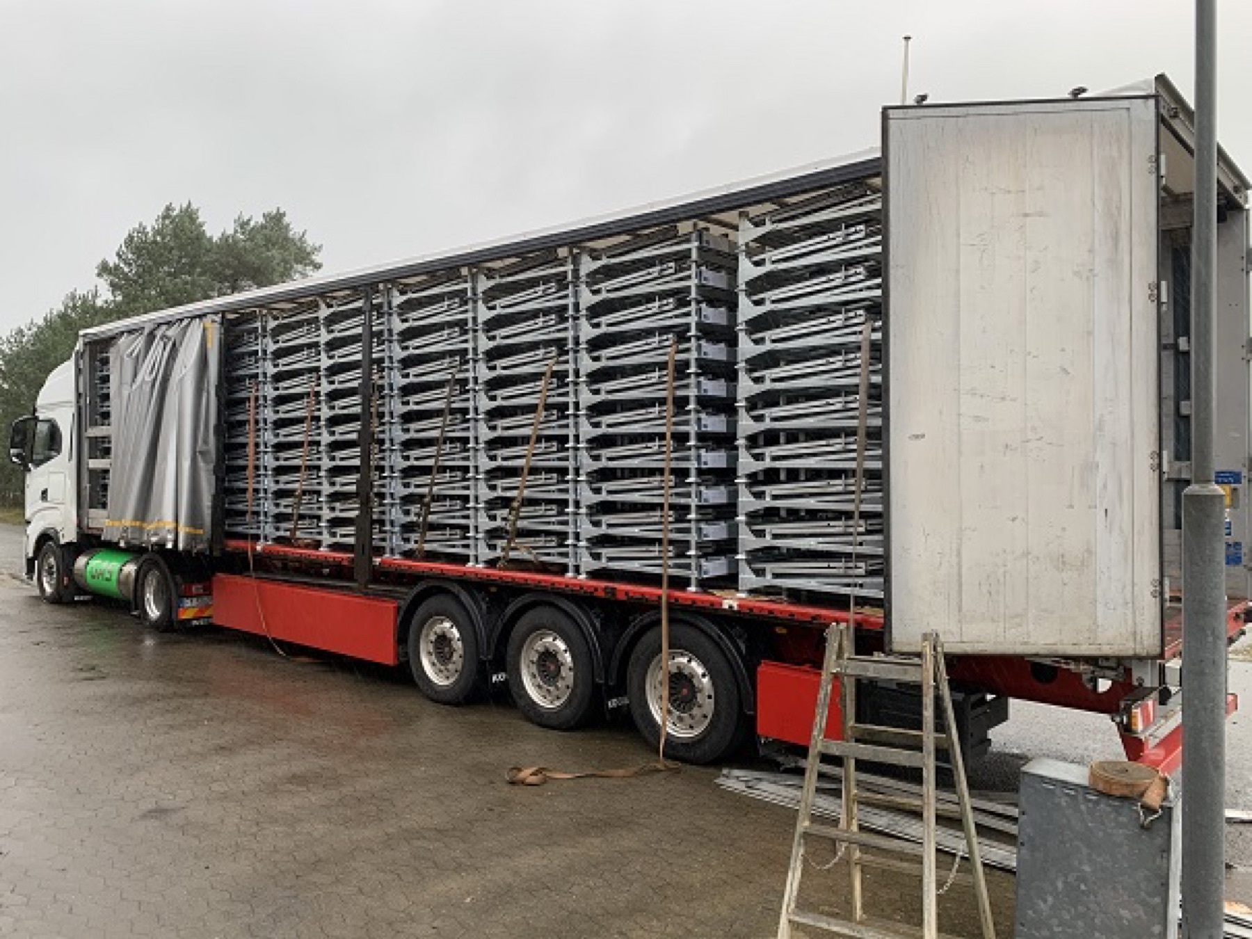 Folded Folding L-Racks stacked in a curtain-side trailer