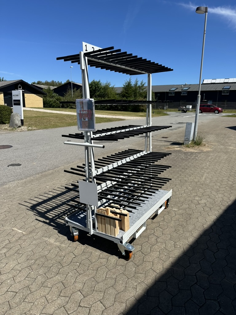 Tall production trolley with multiple shelves and rollers