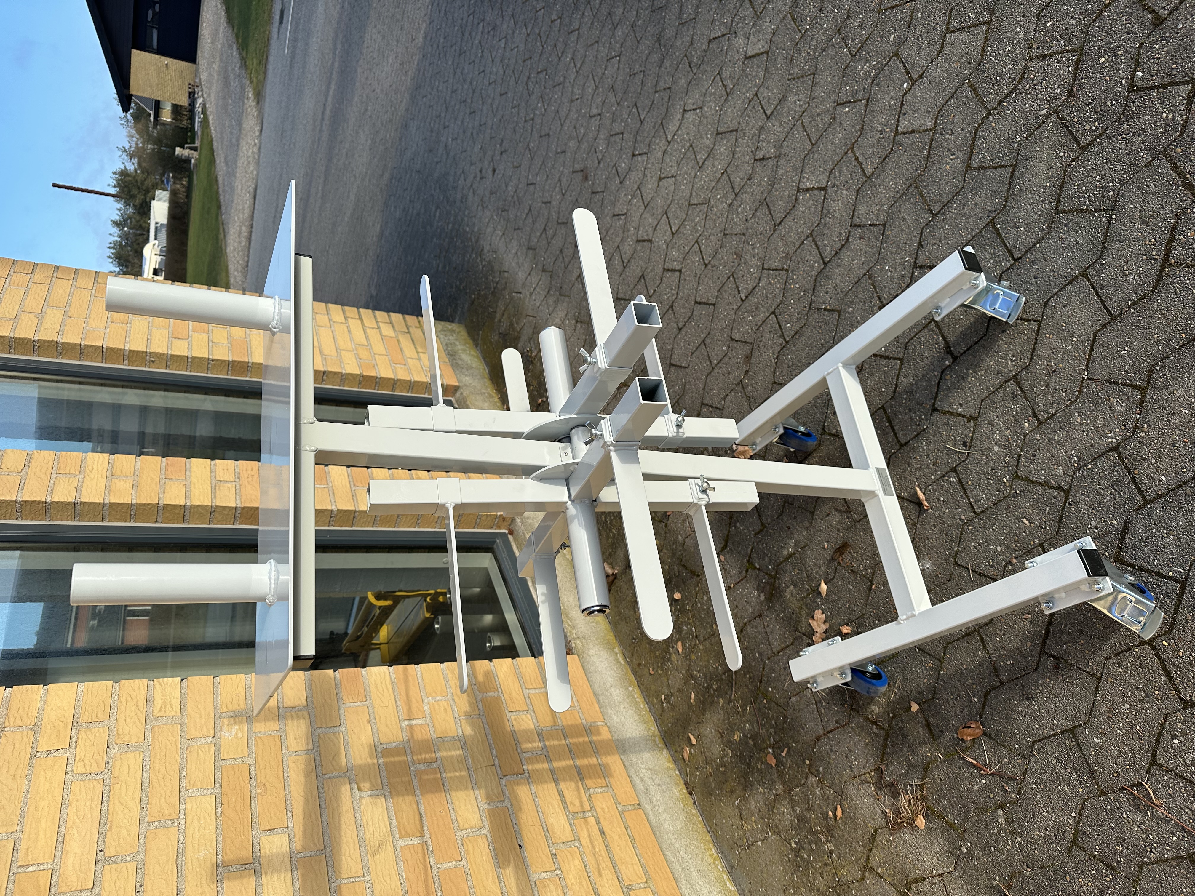 White mobile stand with adjustable arms and supports
