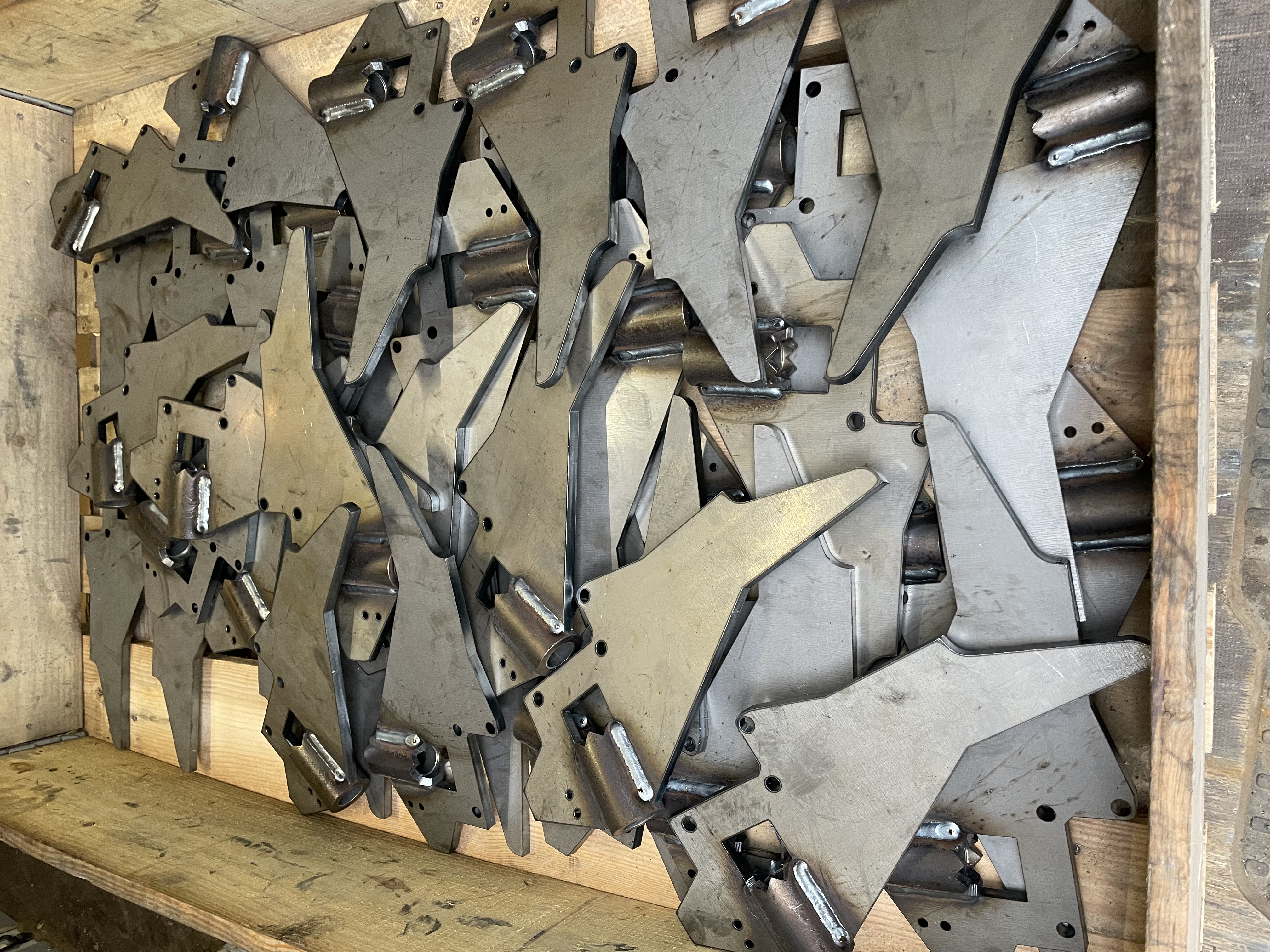 Laser-cut and welded steel brackets in a wooden crate