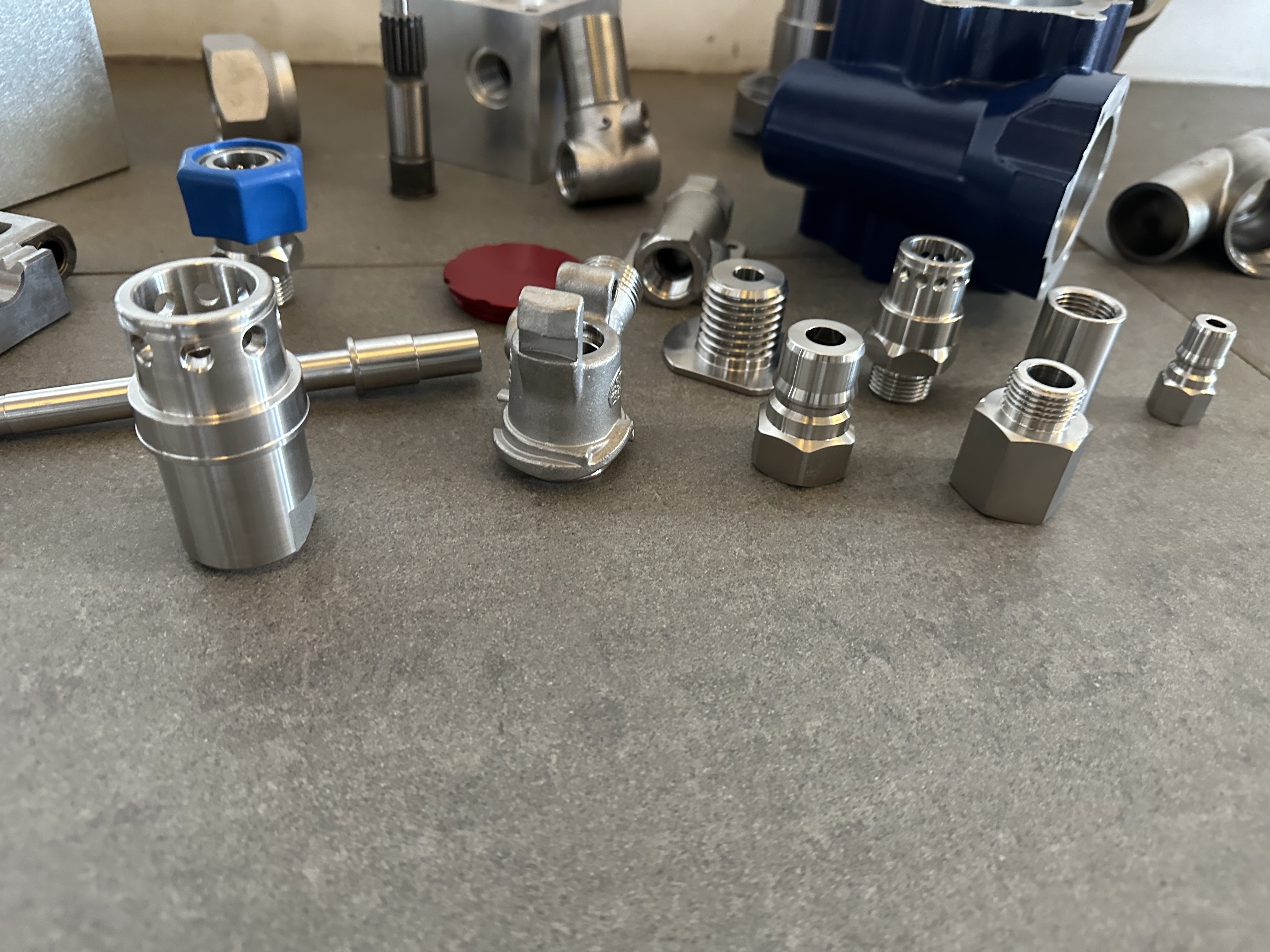 Assortment of machined metal fittings and housings