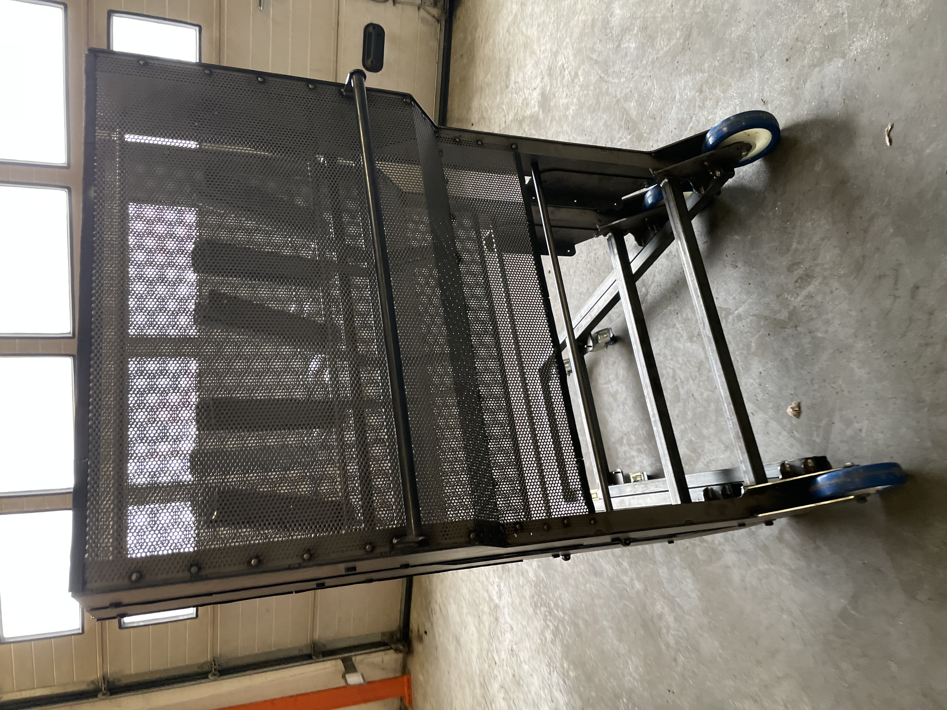 Dark perforated industrial frame on wheels