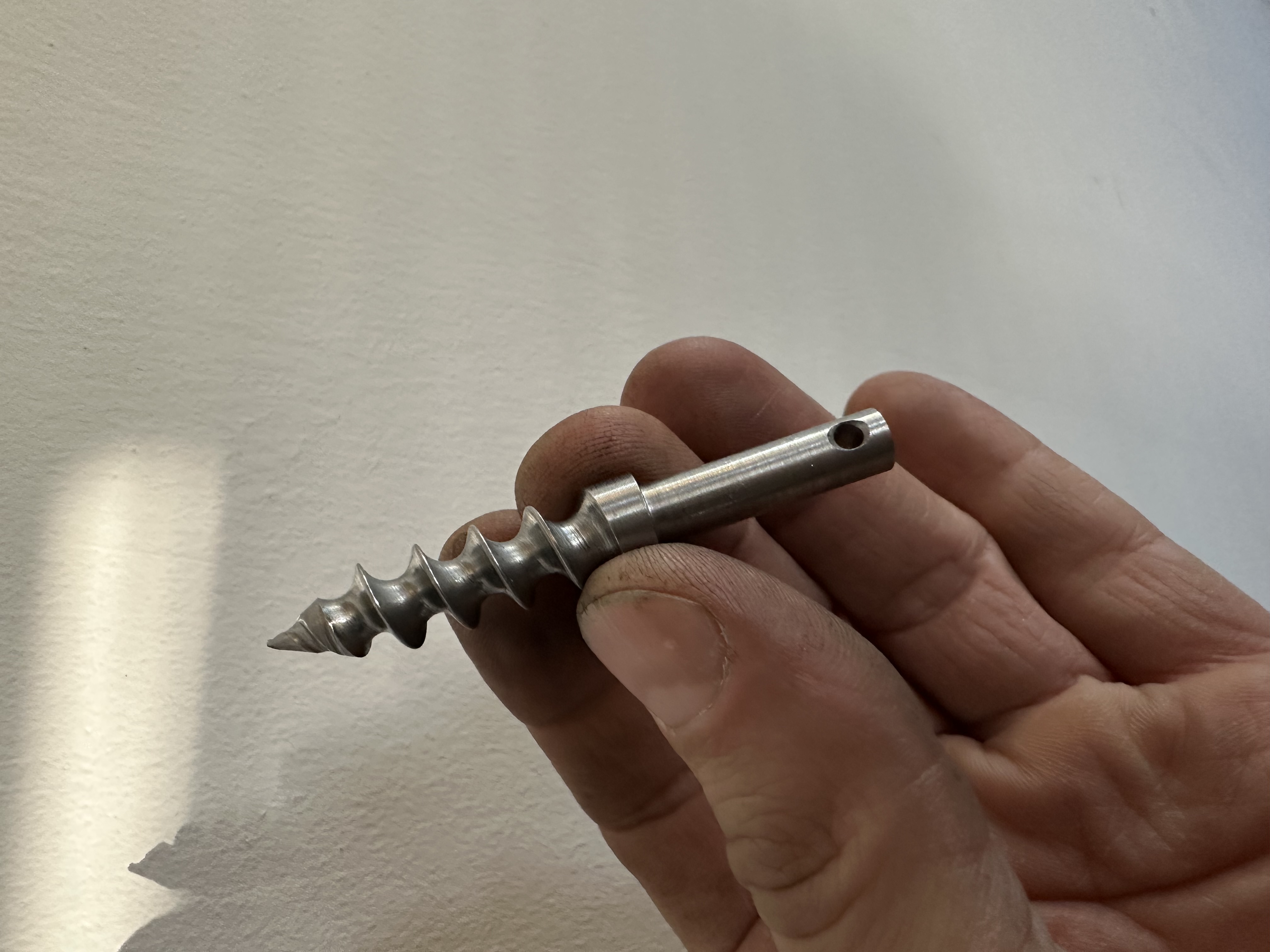 Close-up of a machined stainless steel screw-like component