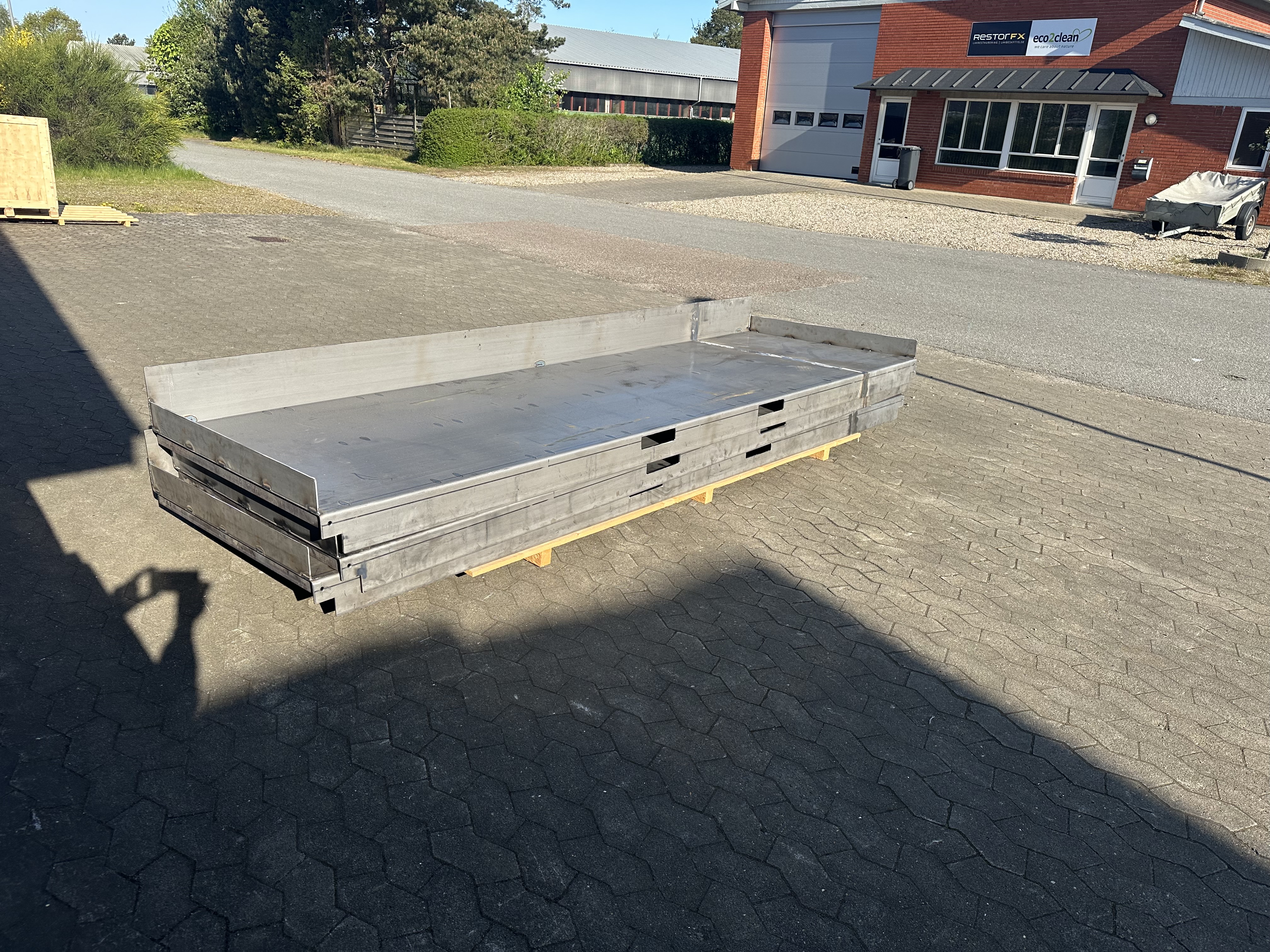 Large fabricated metal platform with raised edges